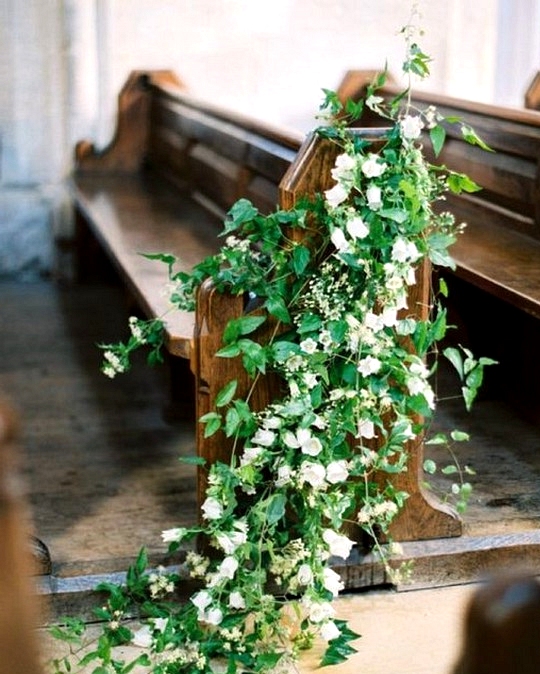 Floral decorated church wedding aisle