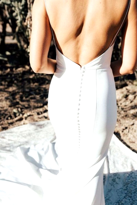 elegant wedding dress with open back and buttons down the train
