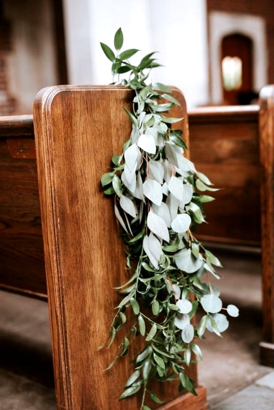 elegant greenery decorated church wedding aisle