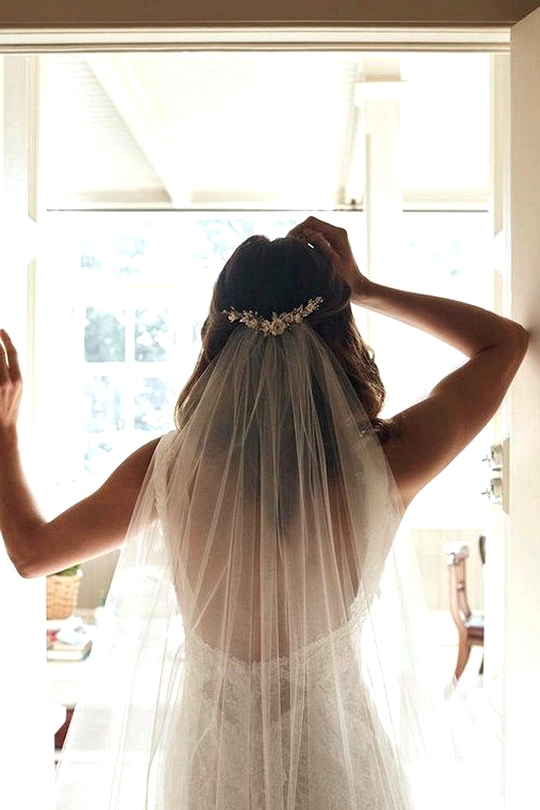 half up half down wedding hairstyle with veil and accessory