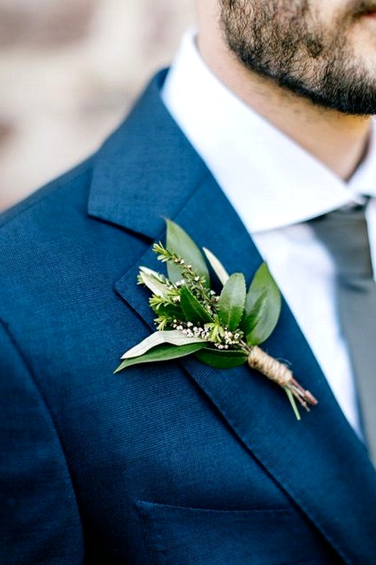 navy blue groom's suit with greenery boutonniere