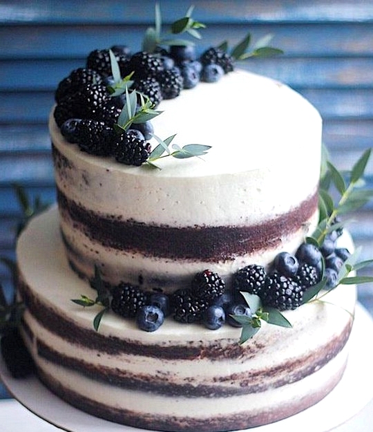 simple wedding cake with cherries and greenery