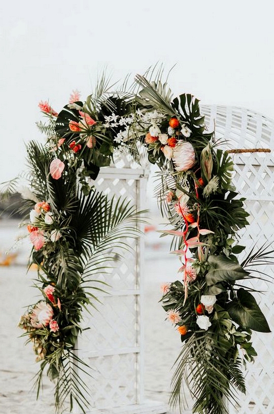 tropical wedding arch ideas with palms and floral