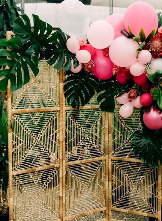 tropical wedding backdrop ideas with greenery and balloons