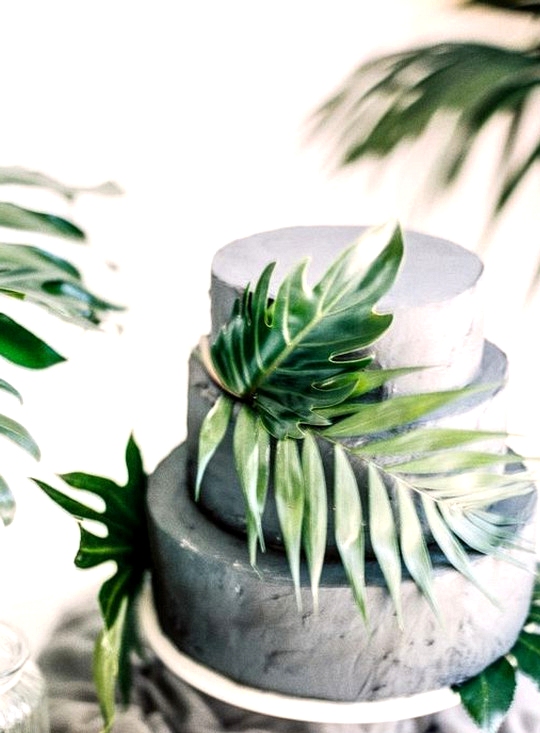gray wedding cake with palm leaves